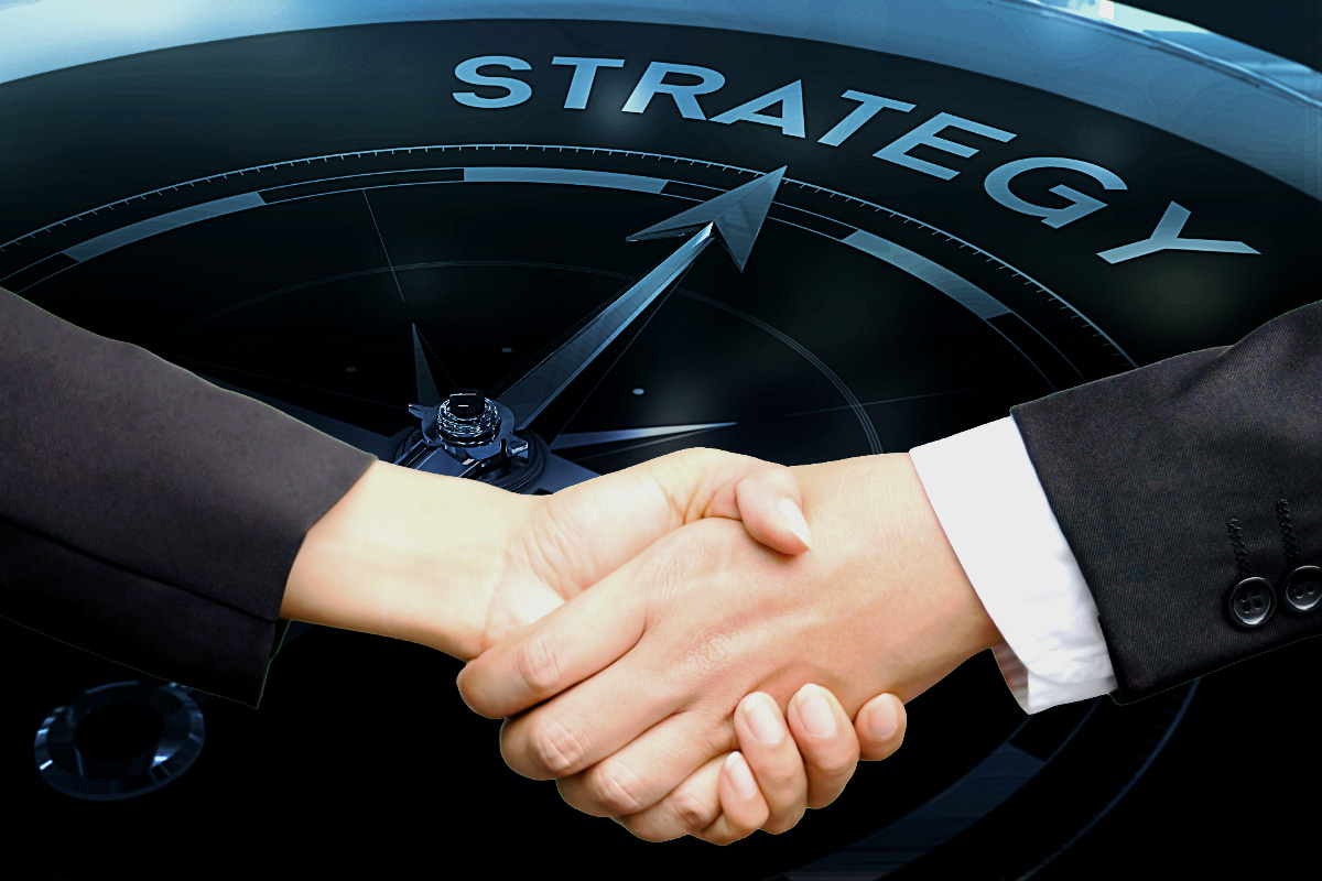 Close-up of a professional handshake in front of a tactical compass pointing to 'STRATEGY,' representing the mandatory entry point and situational awareness alignment for BeeZee Vision mission partners. Alt Text (Spanish): Primer plano de un apretón de manos profesional frente a una brújula táctica que apunta a 'STRATEGY', representando el punto de entrada obligatorio y la alineación de conciencia situacional para los socios de misión de BeeZee Vision.
